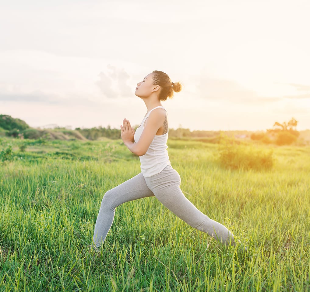 A woman is running through the grass