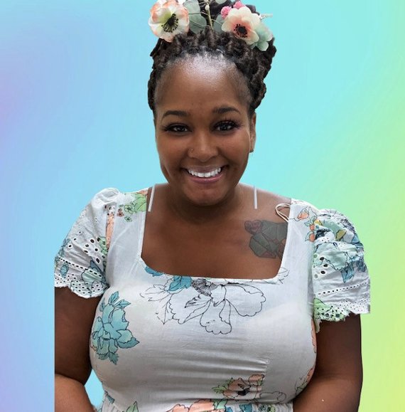 A woman with braids and flowers in her hair.